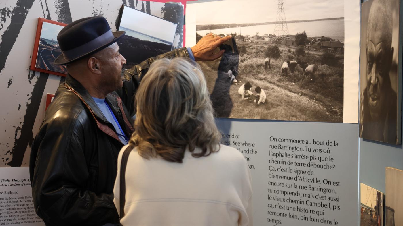 Man and woman looking at information display