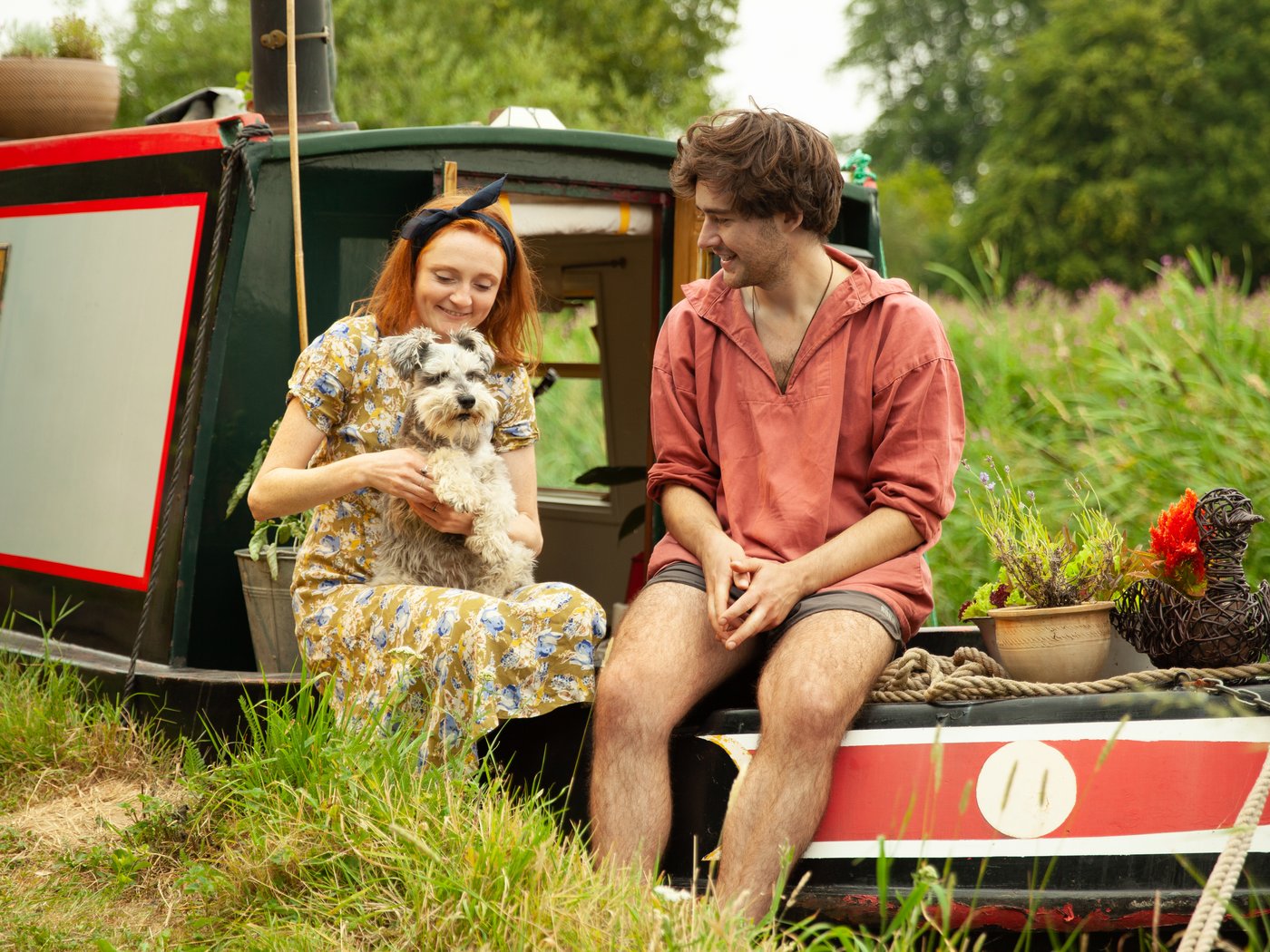 Man and woman on houseboat with their dog
