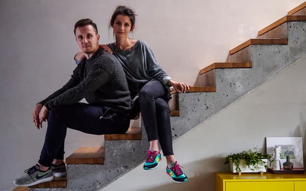 Man and woman sitting on a staircase.