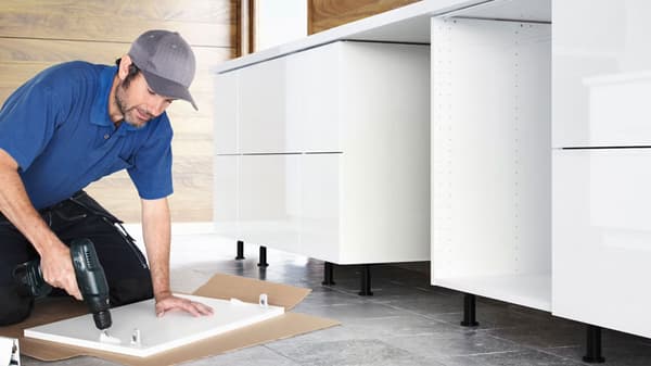 Man building IKEA kitchen