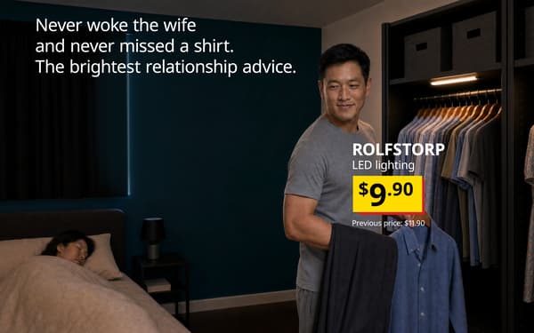 Man choosing a shirt from his wardrobe illuminated by ROLFSTORP LED lighting while his partner sleeps.