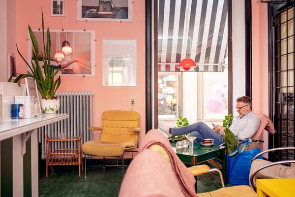Man läser i fåtölj framför fönster
