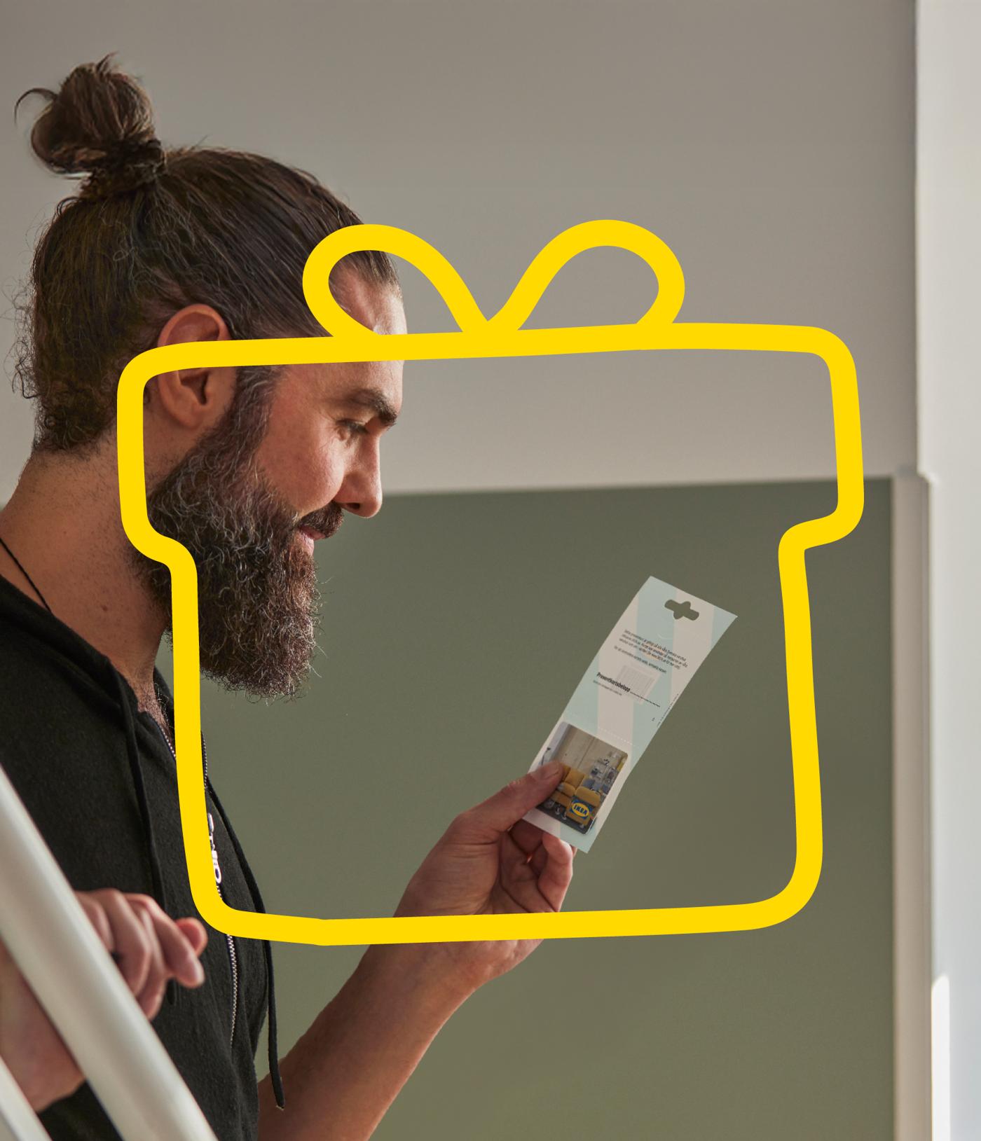 Man looking at IKEA gift card