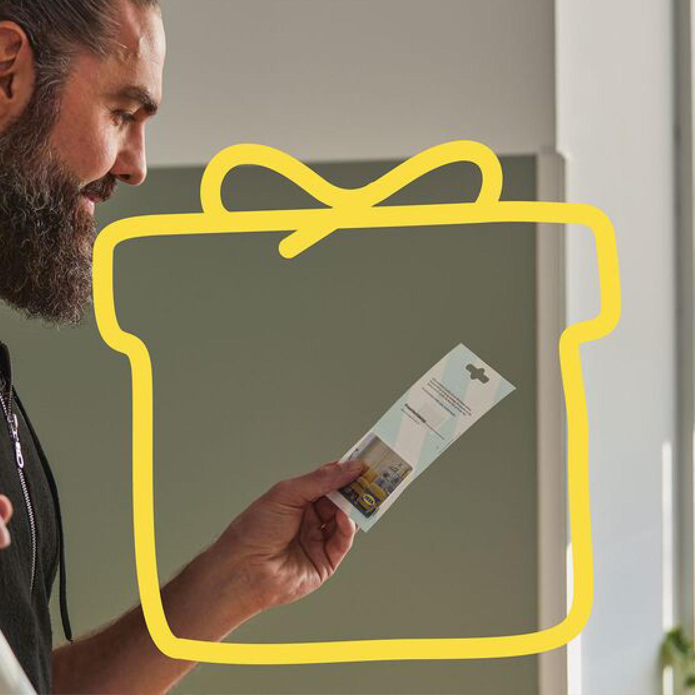Man looking at IKEA gift card