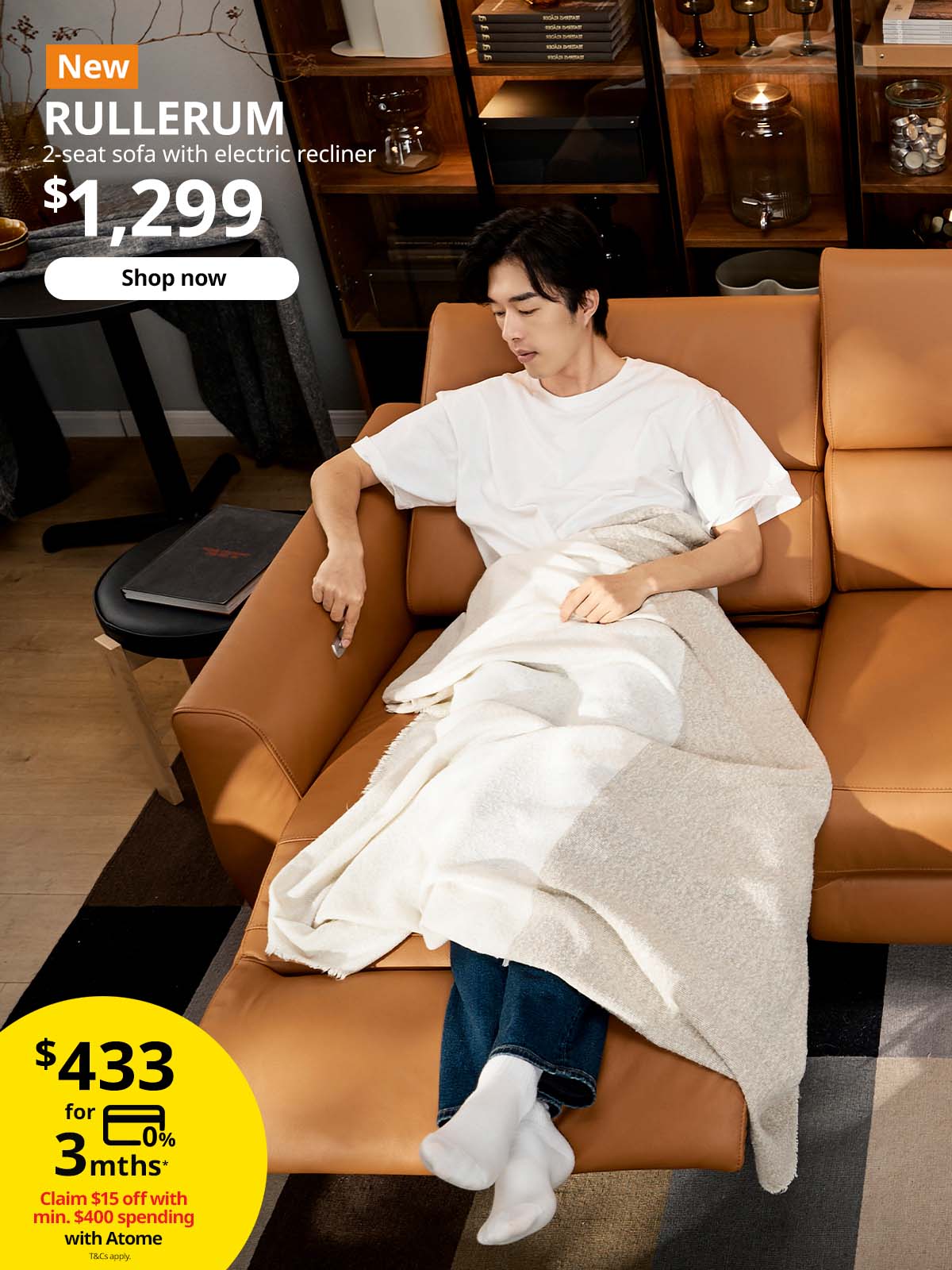 Man relaxing on Grann leather/Bomstad golden-brown RULLERUM 2-seat sofa with electric recliner. $1,299.