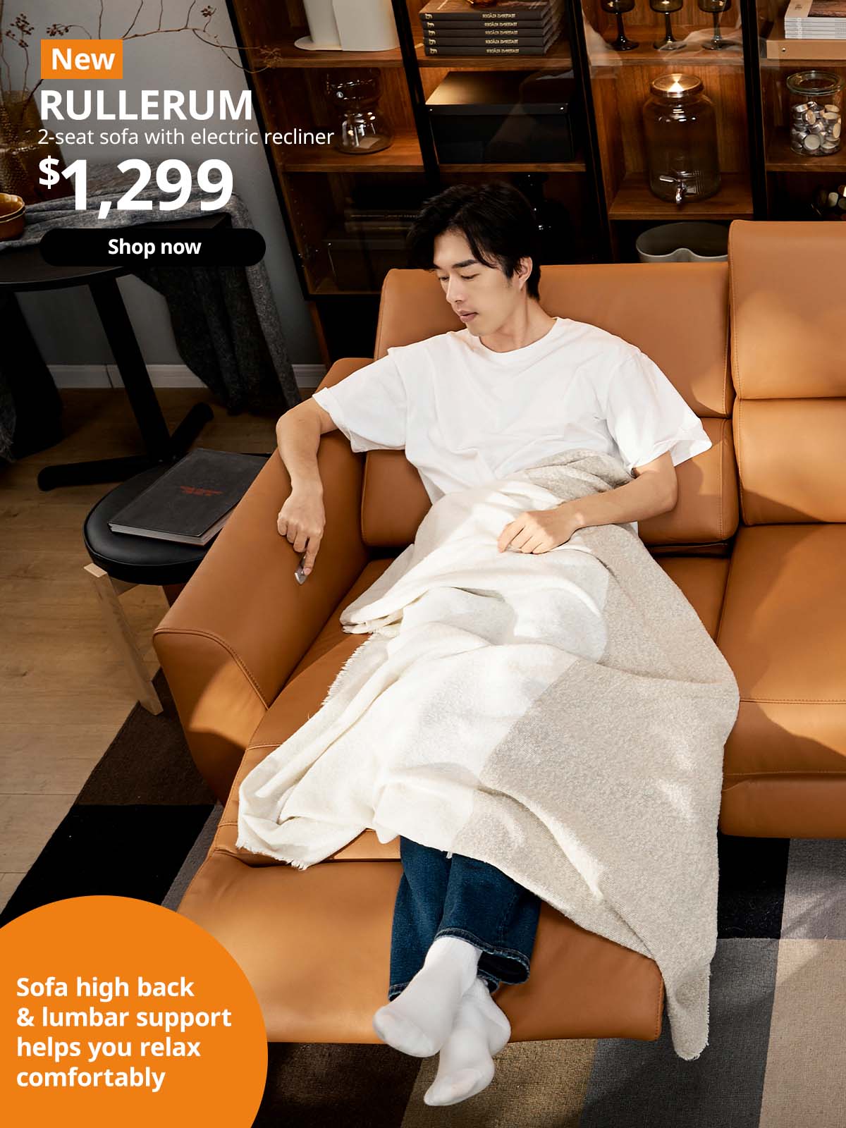 Man relaxing on Grann leather/Bomstad golden-brown RULLERUM 2-seat sofa with electric recliner. $1,299.