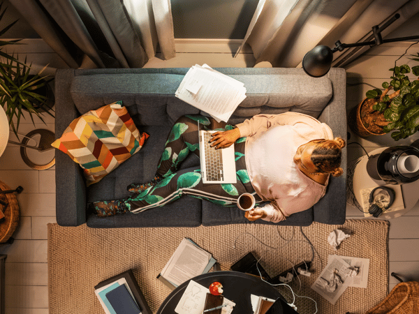 man sitting on couch with laptop