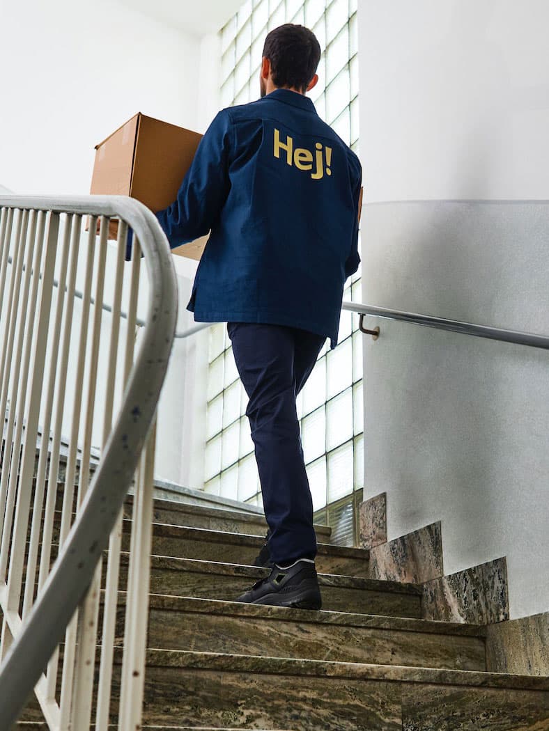 Man walking up stairs carrying box