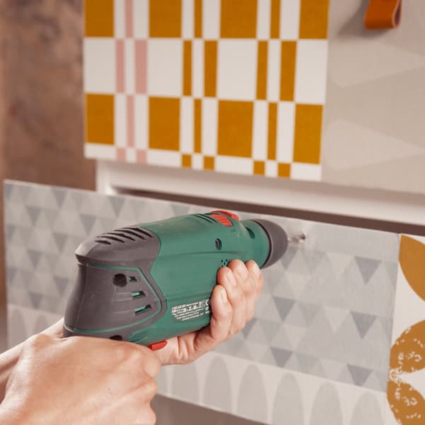 Mark the location of the handles and drill a hole into each drawer.