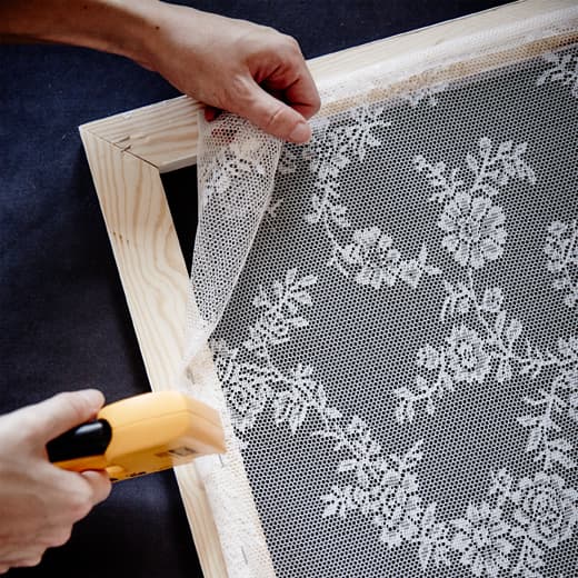 Measure out a wooden frame, then a light lacy fabric and staple in place. After that lean your textile frame in place.