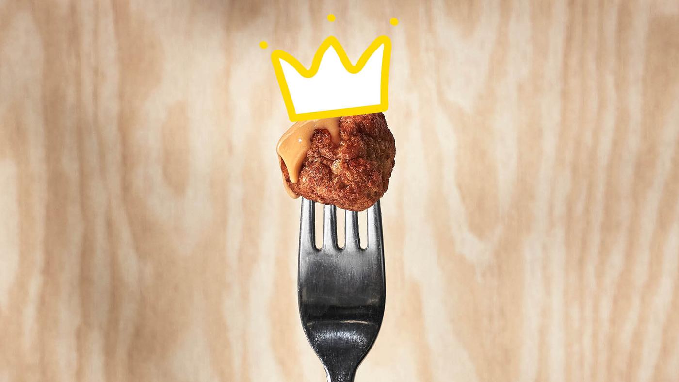 Meatball on a fork, wearing a crown