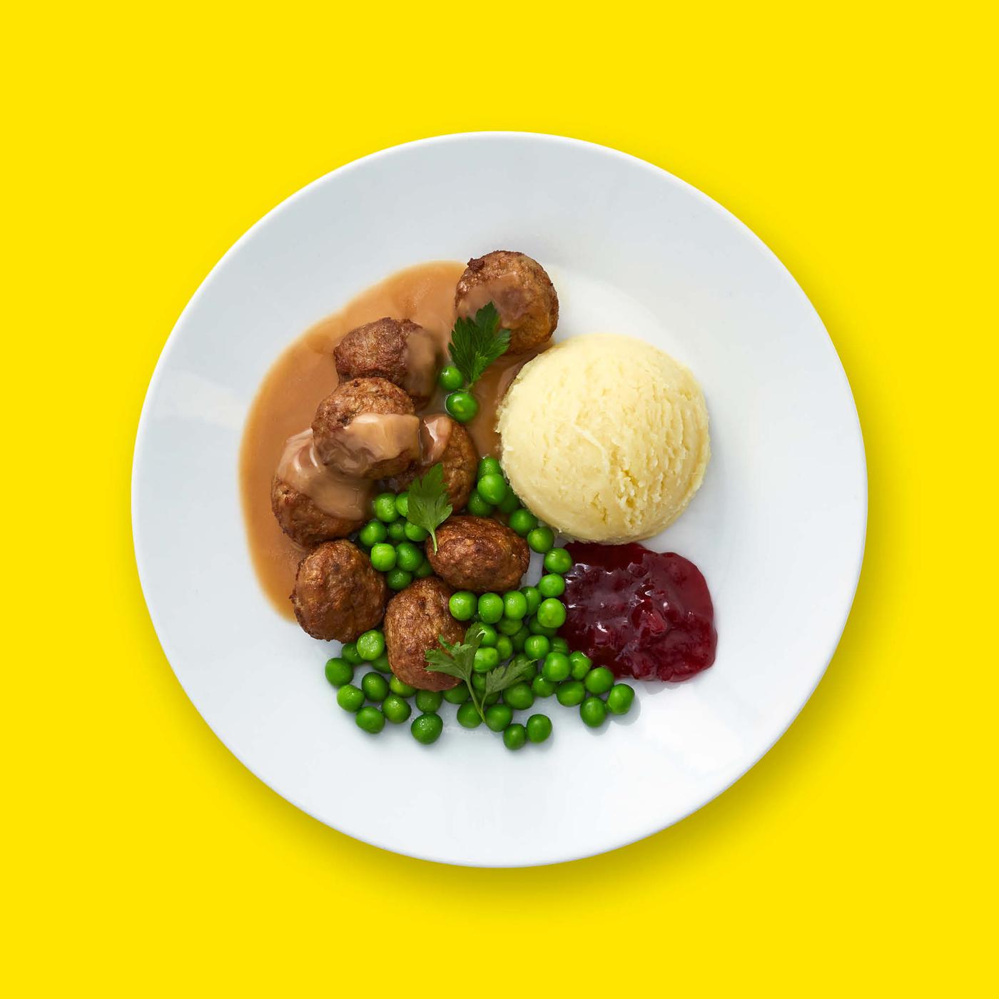 Meatball plate on yellow background.