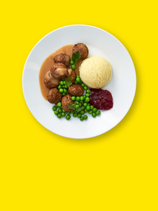 Meatball plate on yellow background.
