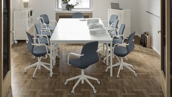 Meeting space consisting of office chairs around  alarge IKEA office table