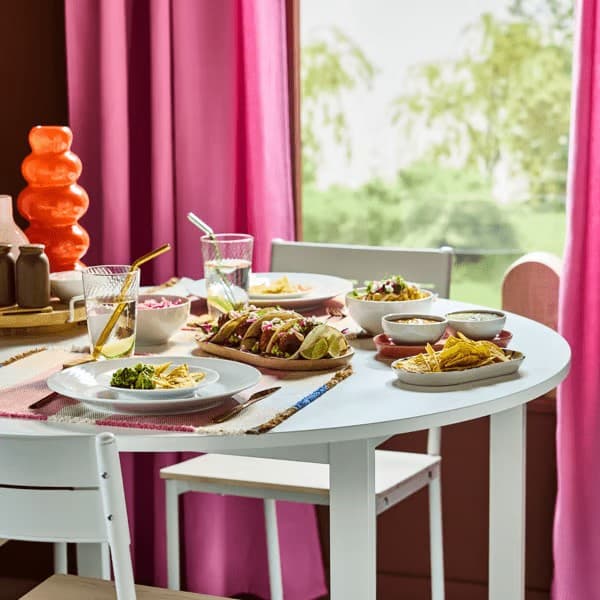 Mexican feast on round white VIHALS table with white IKEA 365+ plates, and transparent ripple-effect KLIPPLAX glasses.