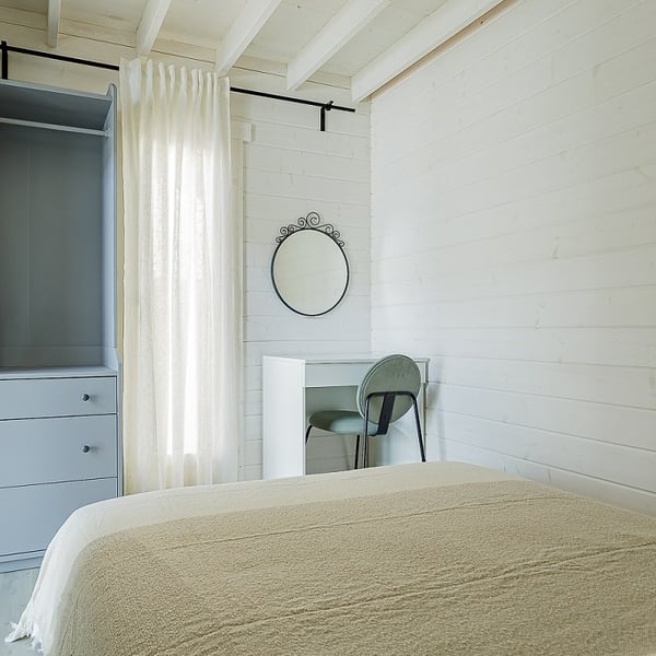 Minimalist bedroom with dressing table and wardrobe in tiny house