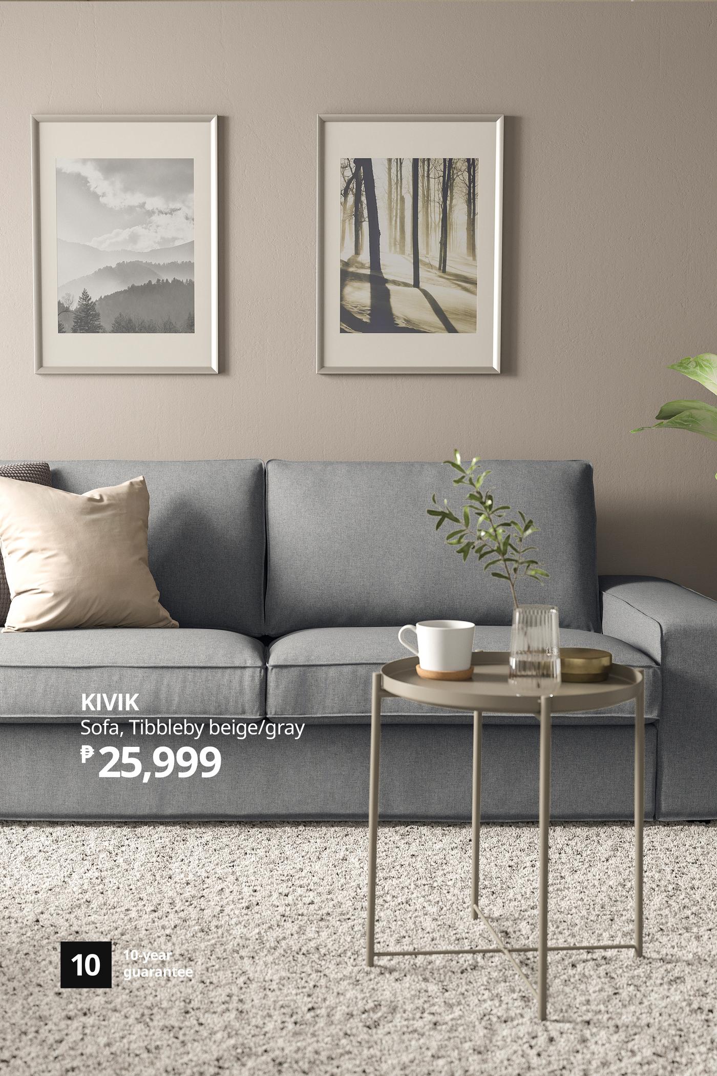 Minimalist living room with a gray IKEA KIVIK sofa, beige pillow, nesting tables and framed nature prints, creating a calm, cozy mood.