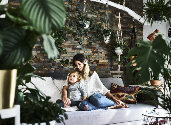 Miriam and her daughter sitting in the living room.