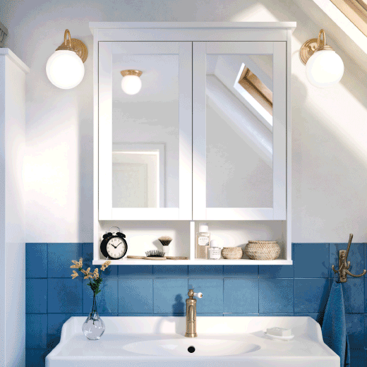 Mirrored cupboards open and close above a white sink with blue wall tiles behind.