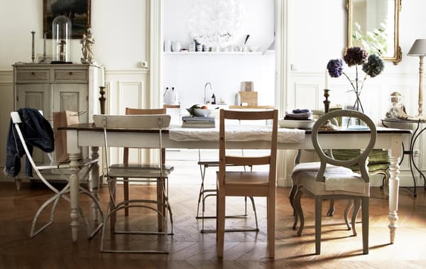 Mis-matched vintage chairs create and informal and relaxed dining area in stylist Hans Blomquist’s home.