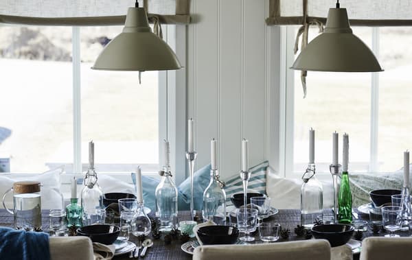 Mismatched bottles and jars make perfect candle holders at a relaxed table.