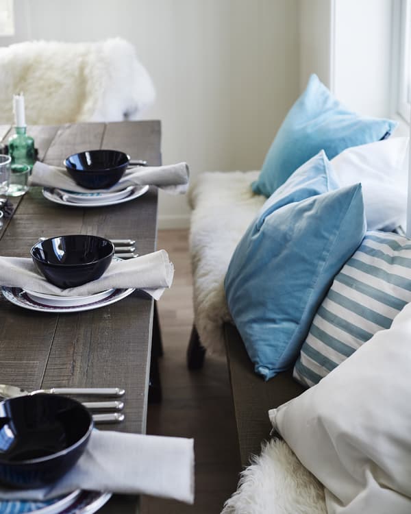 Mix textiles and colour to create a cosy, comfortable seating area that is easy to update each season.