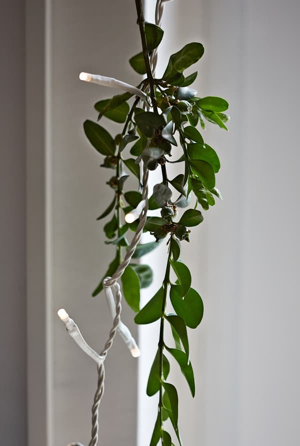 Mix twinkly lights with greenery.
