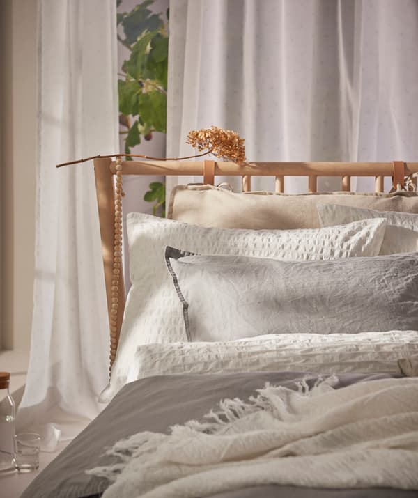 Mixing shades and textures of bed linen creates an inviting, cozy bedding arrangement.