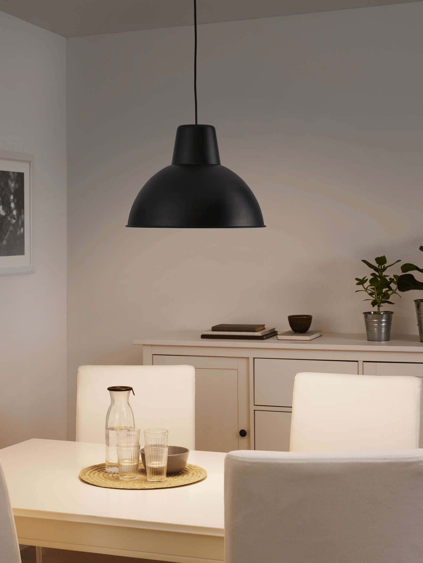 Modern black pendant light hanging above a dining table in a cozy neutral-toned room – Pendant lights from ₹529