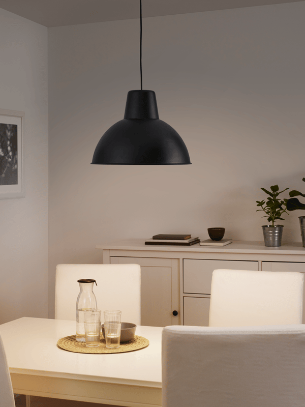 Modern black pendant light hanging above a dining table in a cozy neutral-toned room – Pendant lights from ₹529