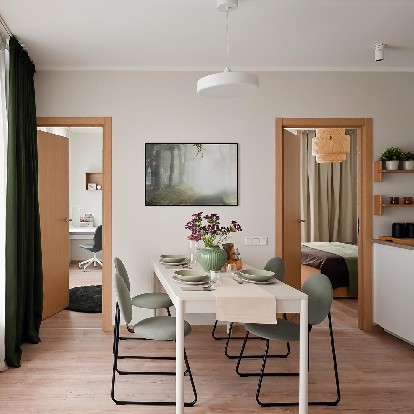 Modern dining area with minimalist furnishings, soft natural tones, elegant lighting, and open-plan connectivity that enhances the sense of space and comfort within the apartment interior.
