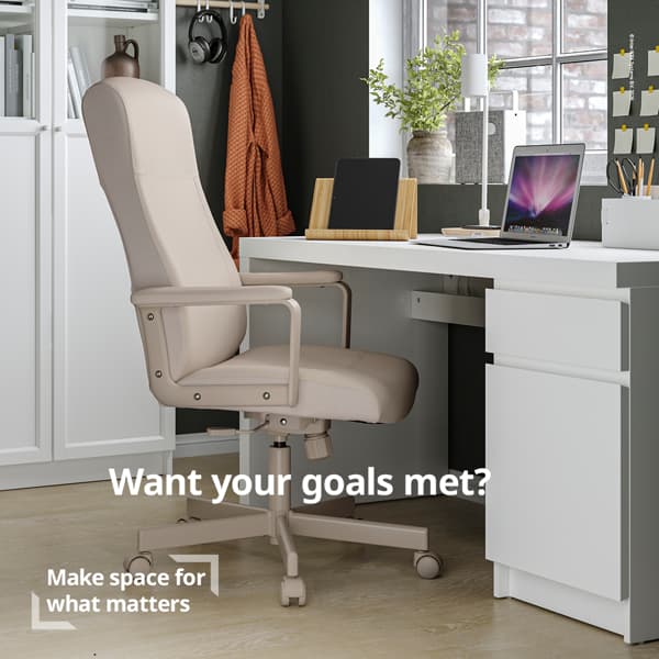 Modern home office with a beige swivel chair next to a white desk, laptop, and vase. Text reads, 