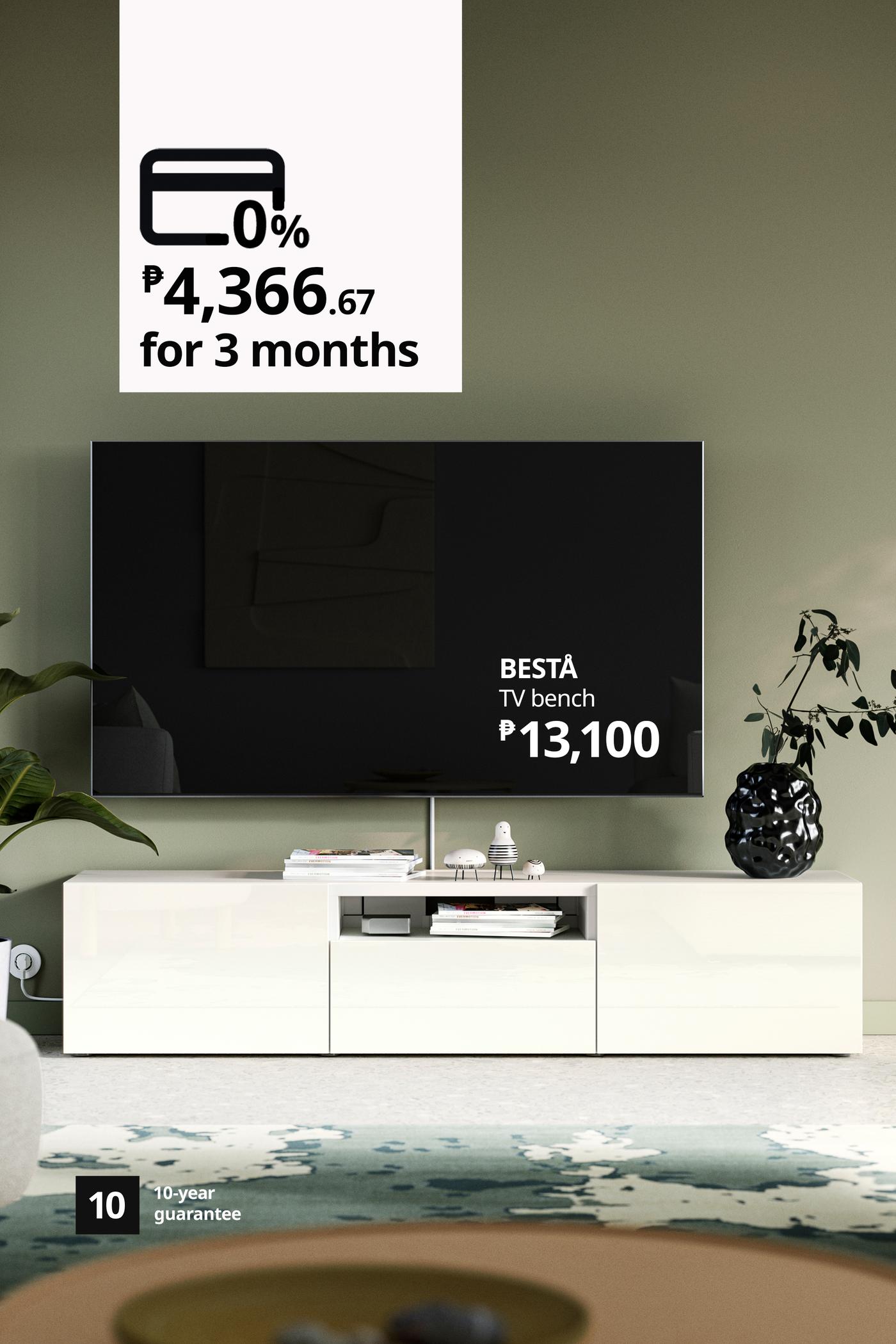Modern living room ad featuring a large TV on a white BESTÅ TV bench, with a plant and rug; financing offer: 0%, ₱4,366.67 for 3 months.