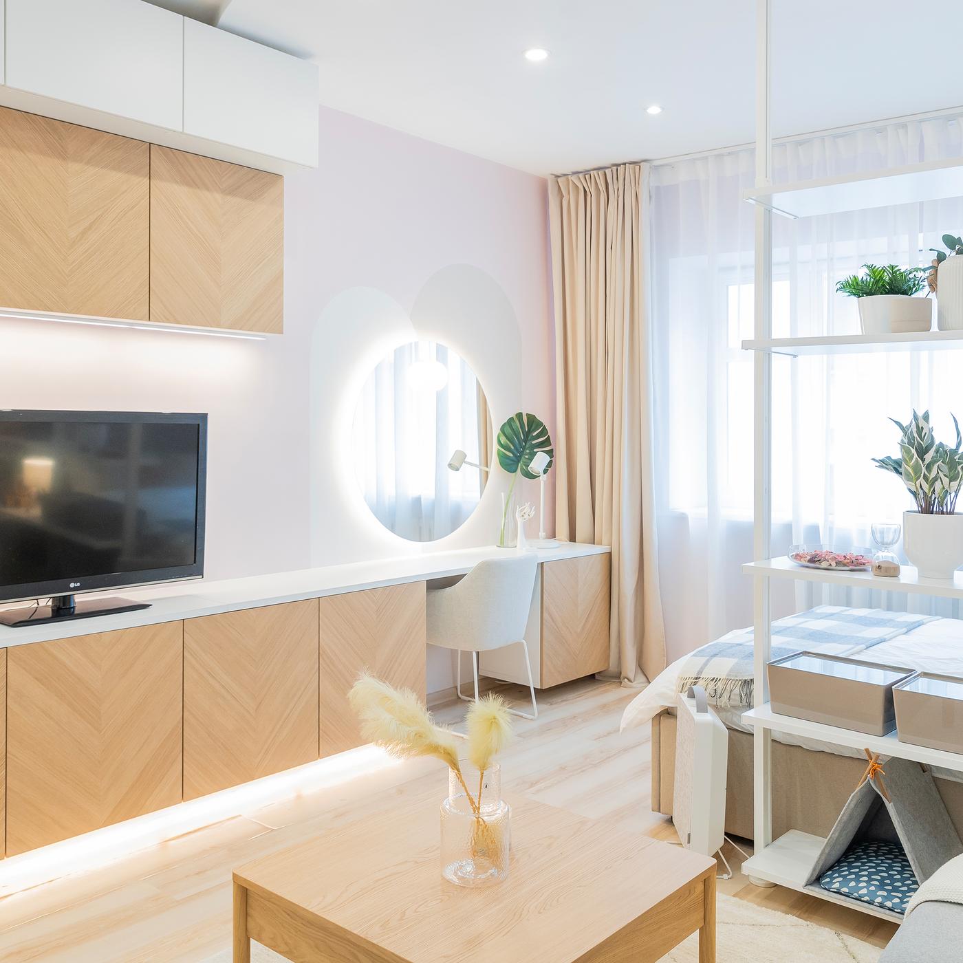 Modern living room with TV, vanity area and soft lighting
