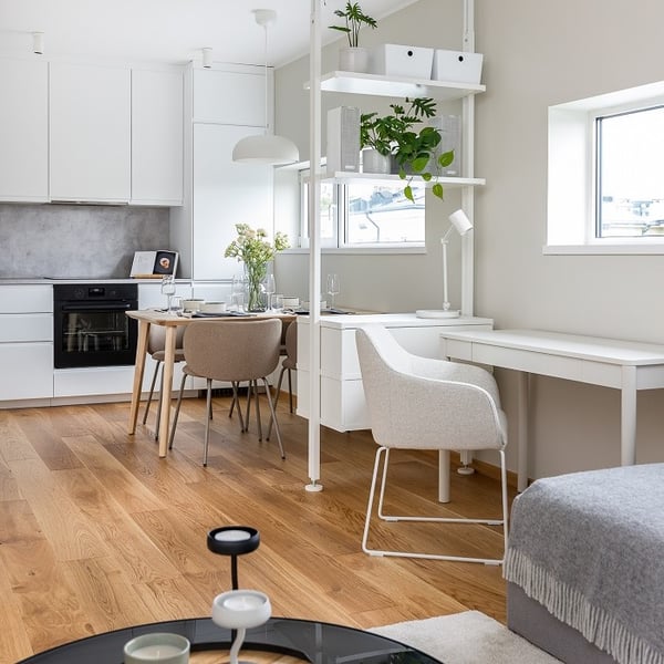 Modern open-plan kitchen with dining area and home office corner