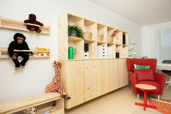 Modern psychologist’s office with warm color palette and organized space after renovation.