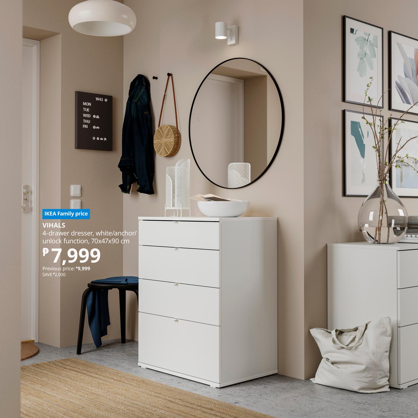 Modern room with a white 4-drawer dresser under a round mirror, decorated with vases. Art on walls, cozy ambiance. Price: ₱7,999, IKEA.