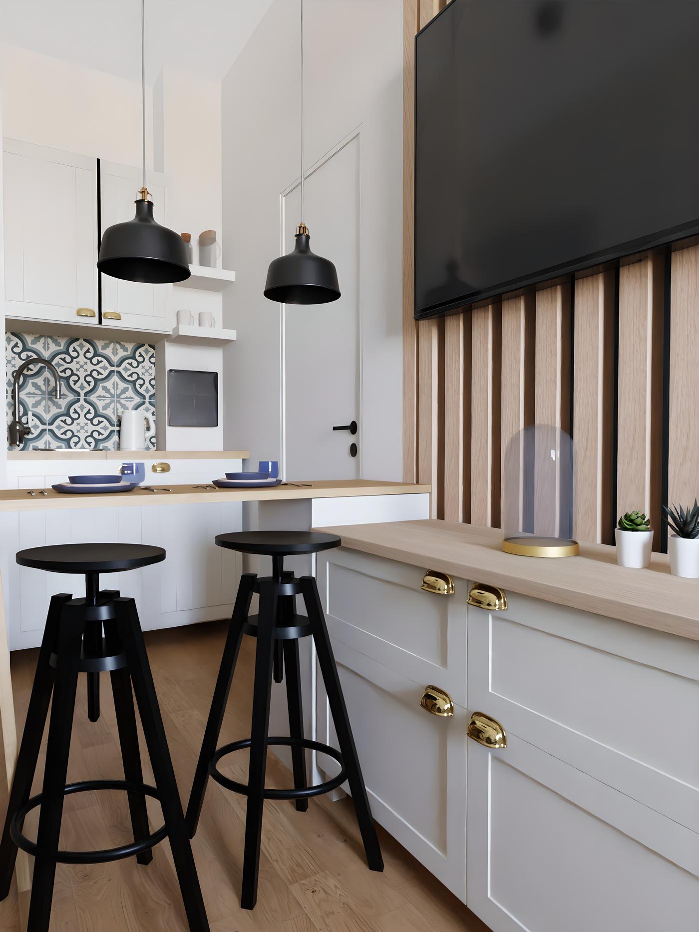 Moderna kuhinja s bijelim ormarićima, crnim stolicama i visećim svjetiljkama, te velikim televizorom na zidu.