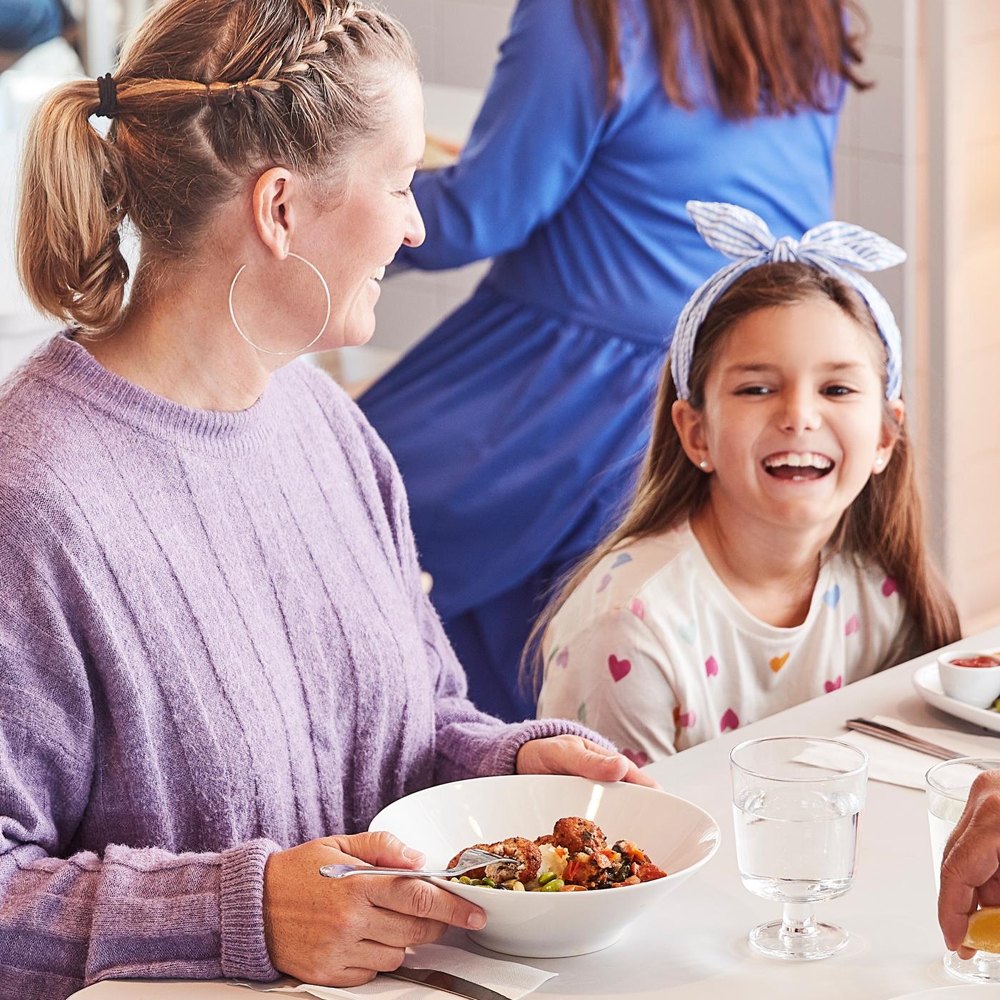 Mother & child eating in Swedish Restaurant.