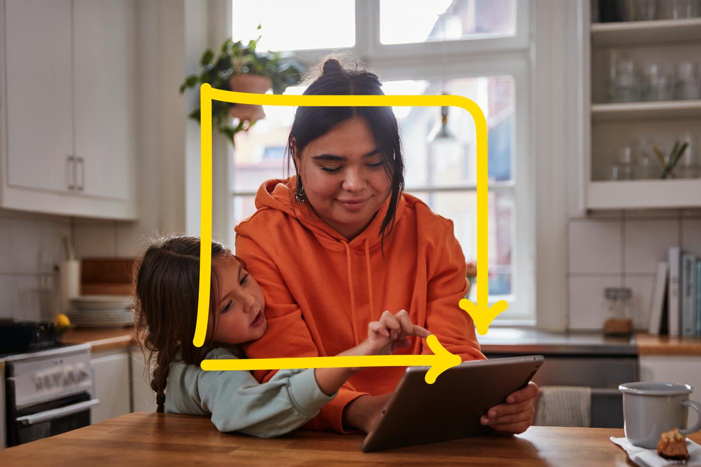 Mother and child holding a tablet.