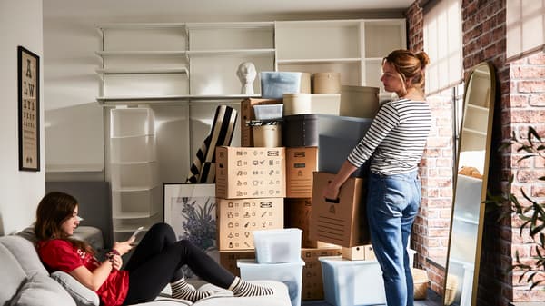 Mother and daughter packing and moving boxes