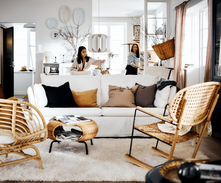 Mother and daughter setting the table in a light-toned room.