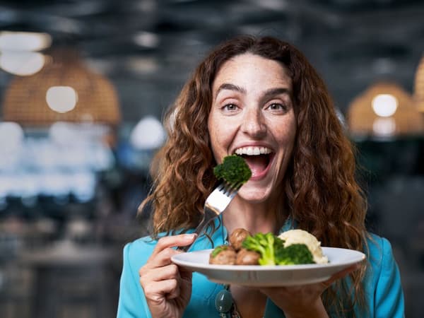 mujer comiendo plato de albóndigas