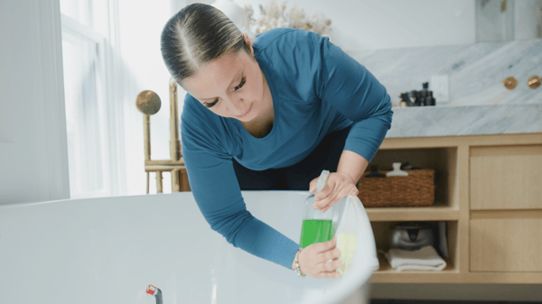 Mujer limpiando bañera