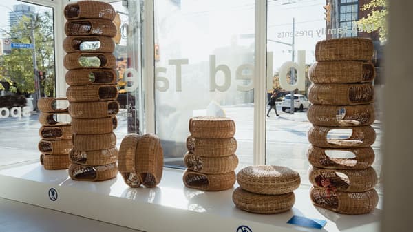 Multiple stacks of ALSEDA footstools are on display by the window of the Tabled Tales gallery.