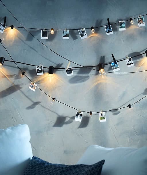 Múltiples cadeas de iluminación LED que adornan unha parede escura