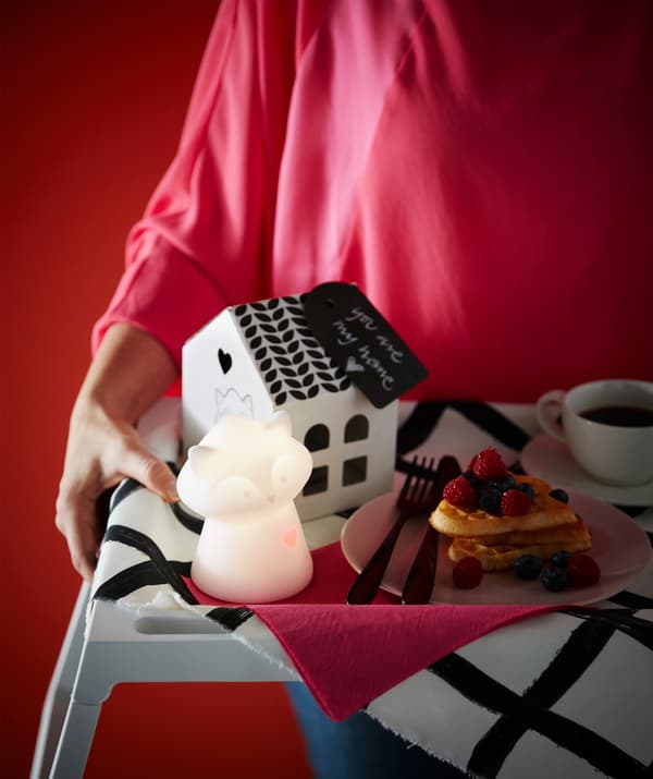 Need Valentine’s Day gifts? Serve up breakfast in bed with products from IKEA. Use a tray to hold heart waffles and a LURIGA night light that’s shaped like a raccoon and has a pulsating red heart. It comes with a little house too.
