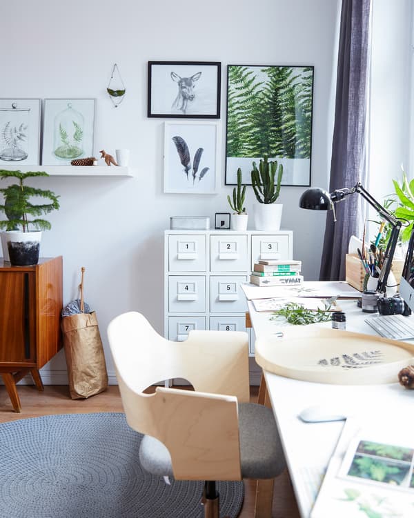 Neutral colors and natural wood create a sense of calm in this home office space that’s part of the bedroom.