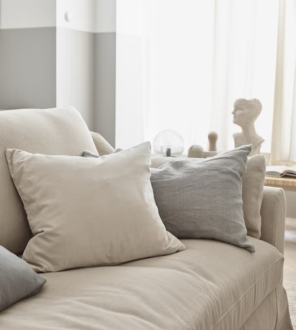 Neutral coloured throws and pillows create a soft feel in the living room.