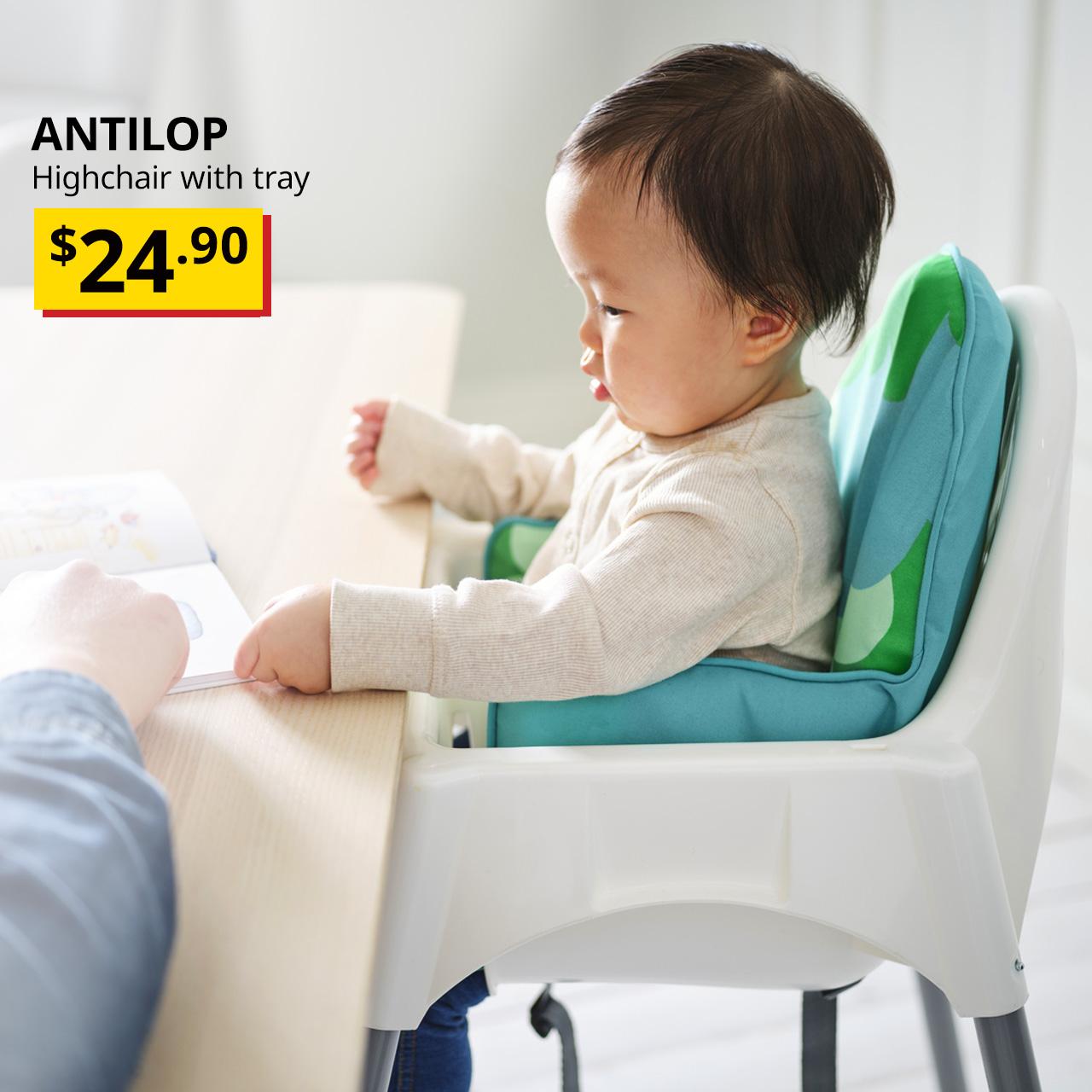 New, baby sits in white ANTILOP highchair with tray facing dining table, $24.90.